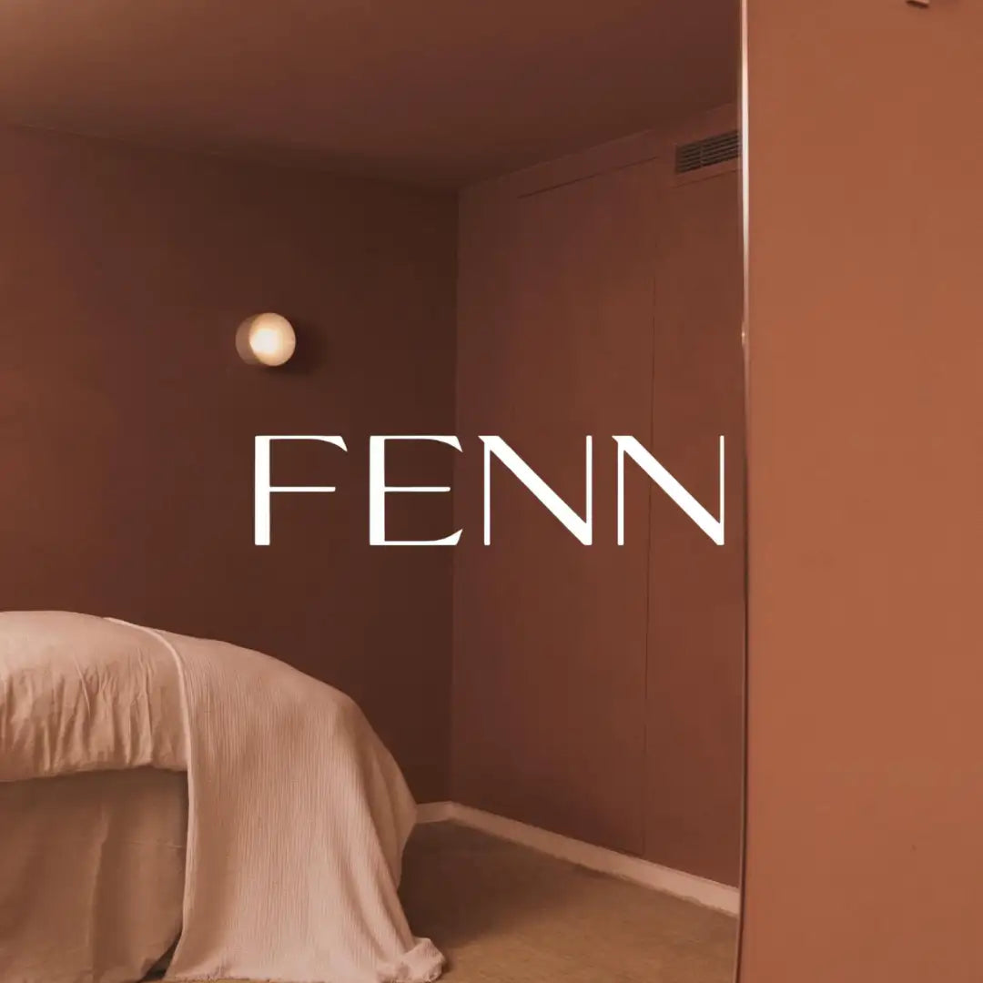 A beige, textured fabric-covered massage table draped with a soft, ribbed cover.